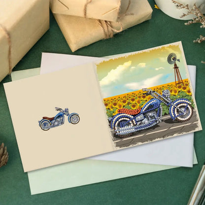 Diamond painting wenskaart met motorfiets in een veld van zonnebloemen naast verpakte cadeaus